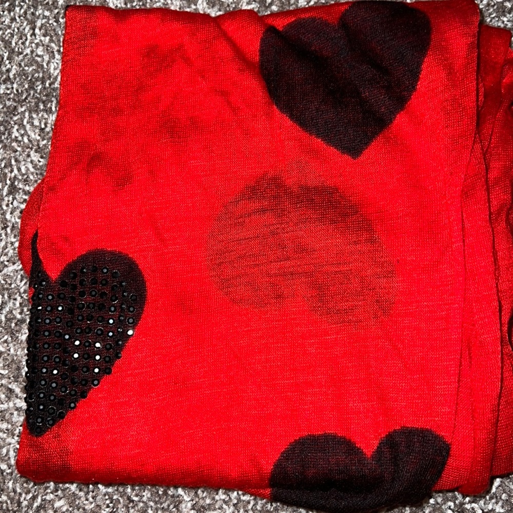 Express red scarf with black hearts. Some of the hearts have black rhinestones.